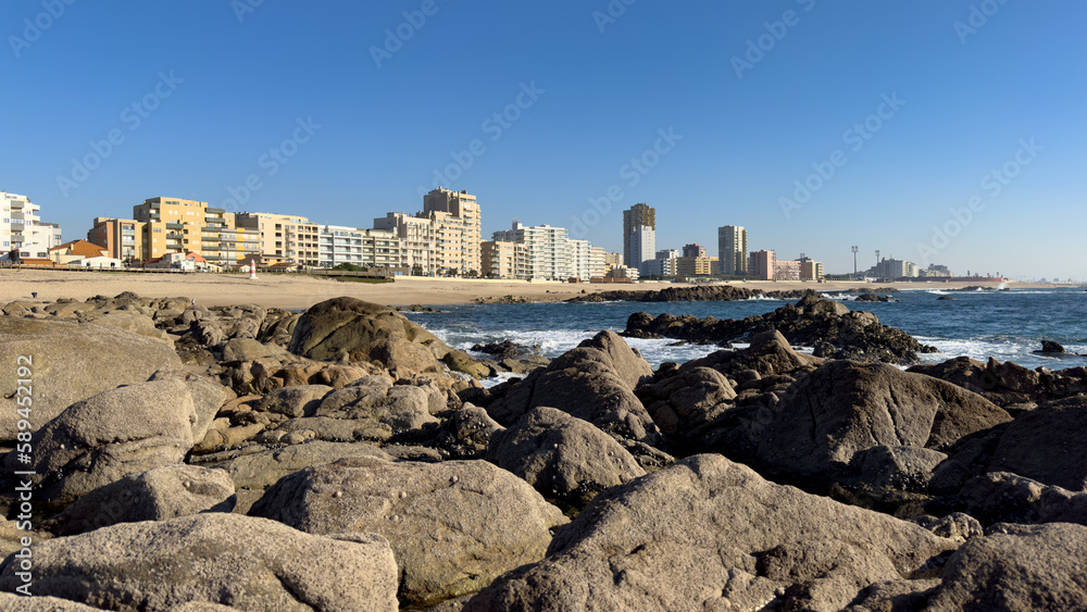 Povoa de Varzim city, Portugal, in spring. View of city from rocks on the beach.