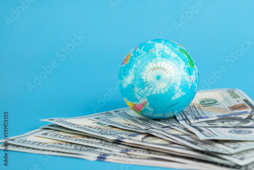 online international banking, Currency exchange, money transfer, globe and cash dollars on a blue background