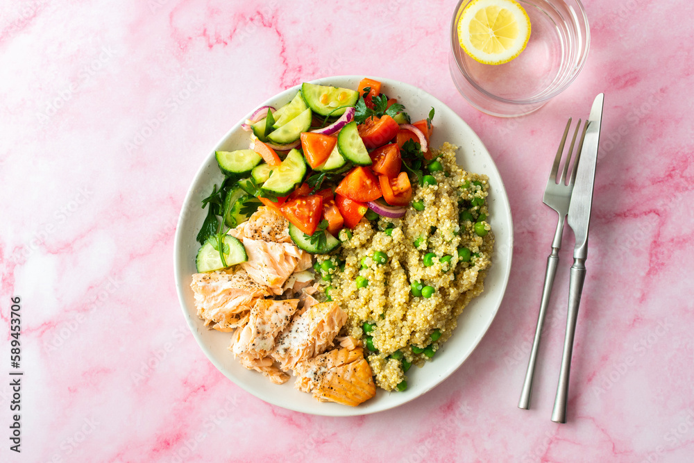 Healthy lunches, quinoa with green peas, with baked red fish salmon and fresh salad of tomato, cucumber and greens, top view Healthy lunches, quinoa with green peas, with baked red fish salmon and fresh salad of tomato, cucumber and greens, top view