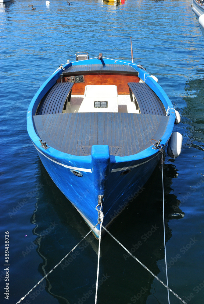 Blue Painted Wooden Boat on Calm Waters of Lake in Close Up 