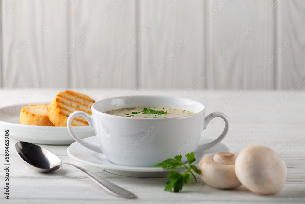 Mushroom cream soup on a white wooden board. side view Mushroom cream soup on a white wooden board. side view