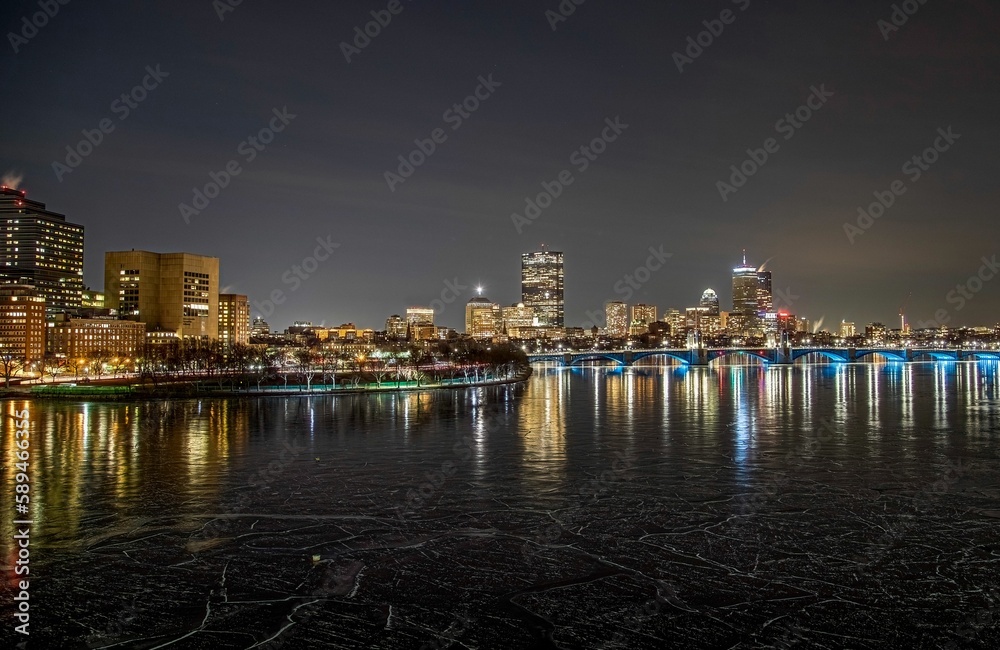 Fototapeta premium the riverfront bridge leads to a wide city with tall buildings