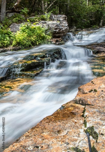 a close up view of some rocks and water in a stream