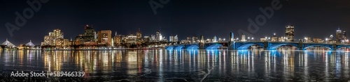 an icy river with many lights on and cityscape in the background