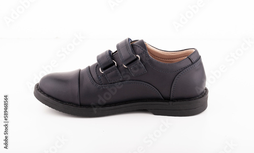One black leather shoe on a white background. Right