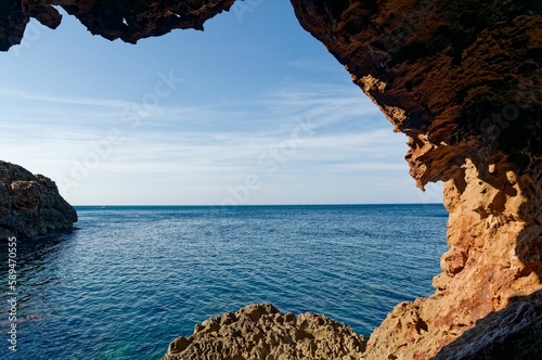 Rocks of the Cave cova tallada near the coast in Alicante, Spain © M  Hieber/Wirestock Creators