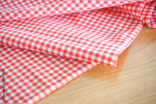 classic pink and white tablecloth background on wood table with selective focus