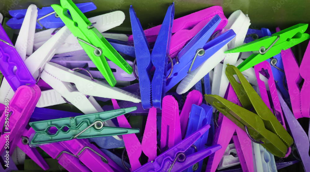 Fototapeta premium Heap of vivid blue and purple color clothespins