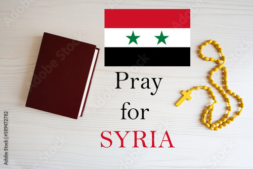 Pray for Syria. Rosary and Holy Bible background.