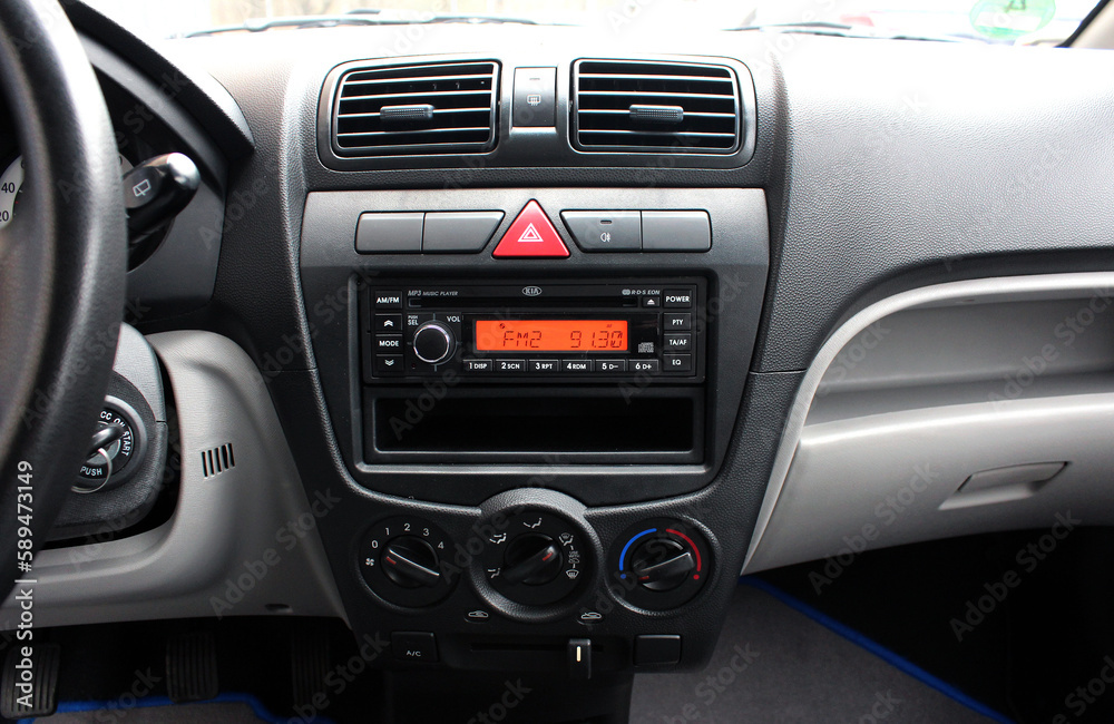 Multimedia radio cd controls. Modern car climate control panel for driver and passenger. Zone climate control. Car interior detail. Multimedia radio cd controls. Modern car climate control panel for driver and passenger. Zone climate control. Car interior detail.
