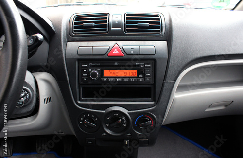 Multimedia radio cd controls. Modern car climate control panel for driver and passenger. Zone climate control. Car interior detail.