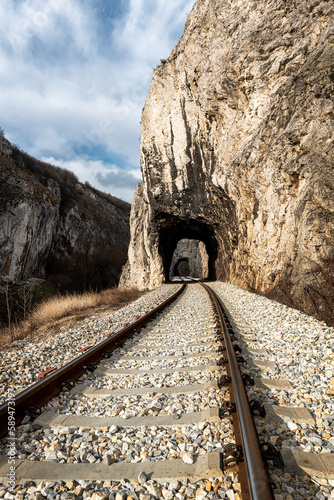 Old railway passing through short tunnels in picturesque rural scenery