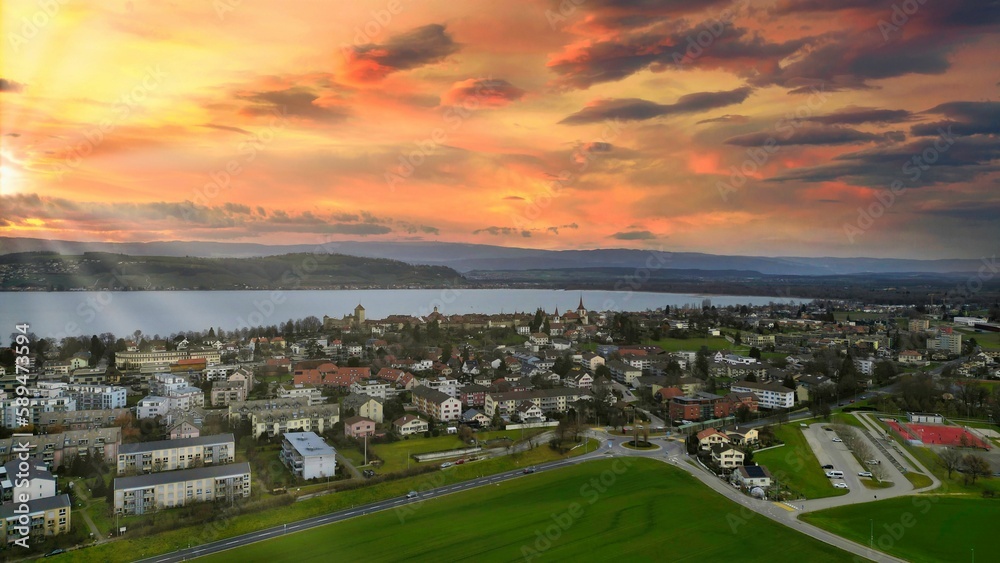Aerial view of the town of Murten in Swizterland during a vibrant sunset in the sky