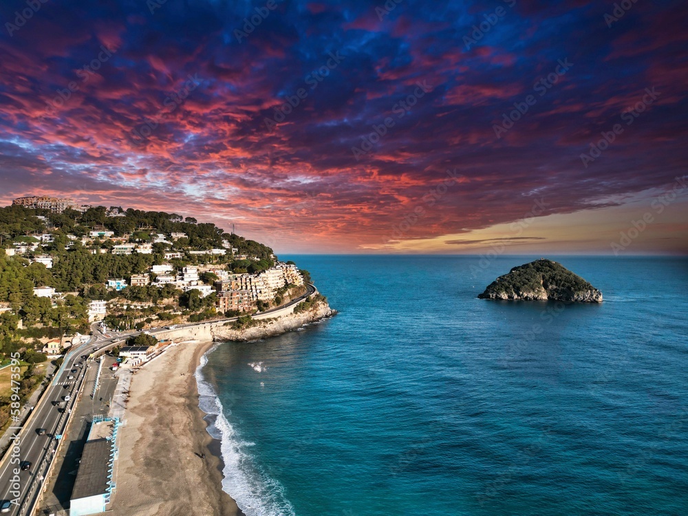 Beautiful sunset on the beach of a town near the ocean in Italy
