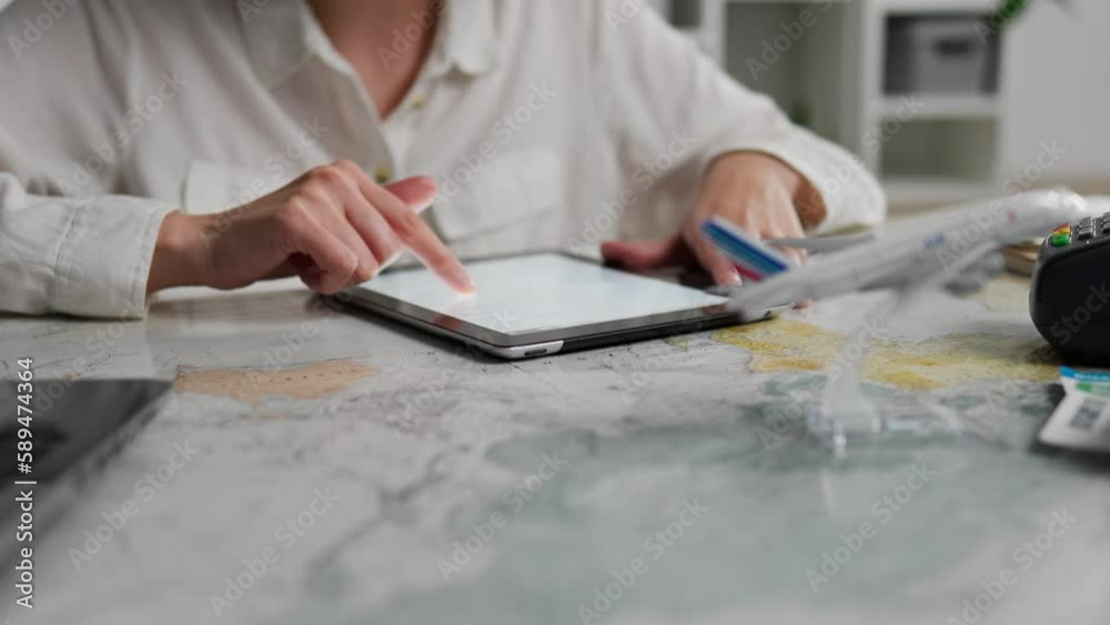 Operator, Experienced Consultant Concentrated Works on an electronic tablet. Tablet screen, Indoors In slow motion Consultant girl manages affairs To help clients travelers, airplane
