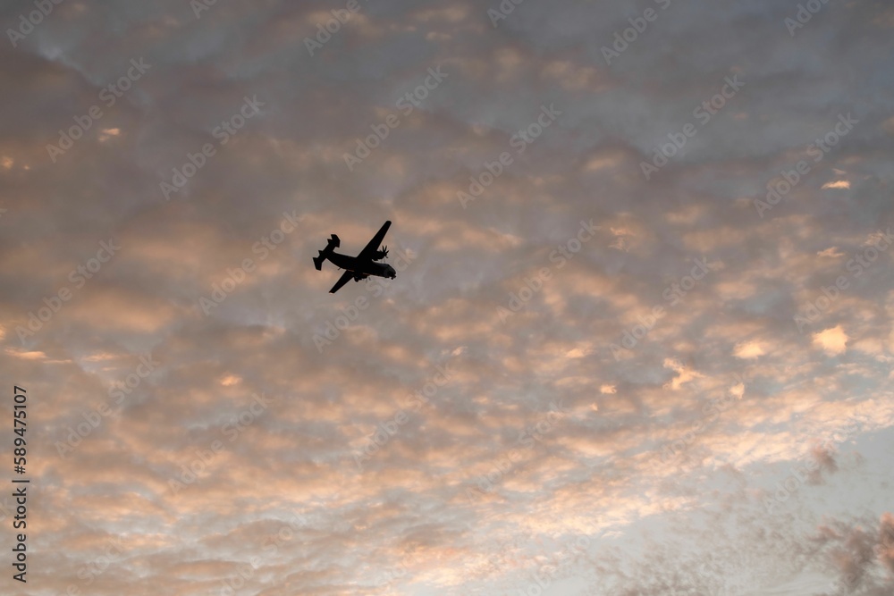 Silhouette of a military airplane flying in the clouds at sunset in Coronado, San Diego. Silhouette of a military airplane flying in the clouds at sunset in Coronado, San Diego.
