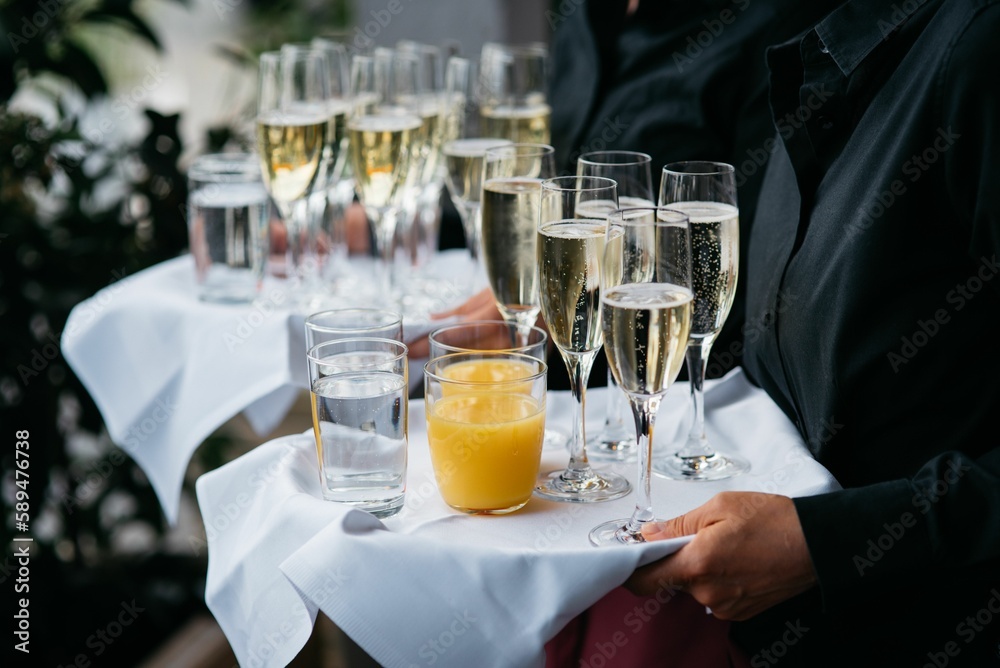Waiter with sparkling wine, water and orange juice Waiter with sparkling wine, water and orange juice