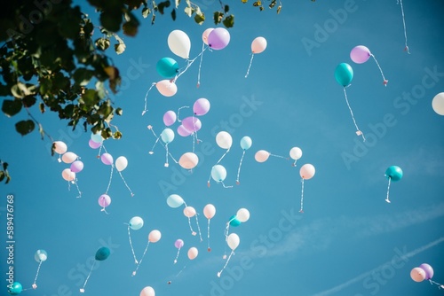 Low-angle shot of the Colorful balloons with cards in the sky