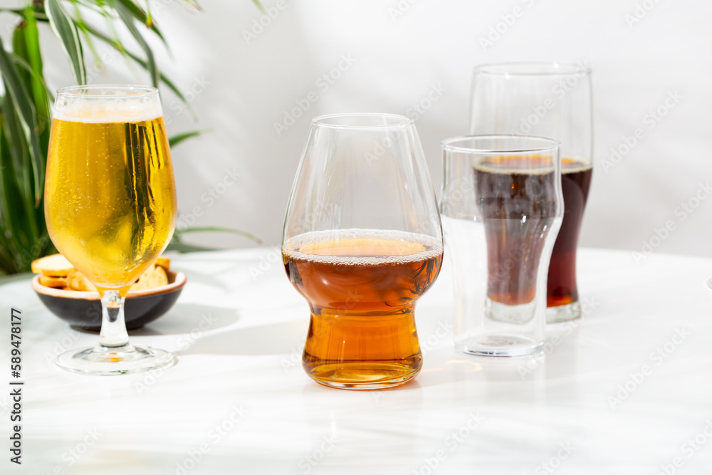 Glass with light beer dark empty on light background Glass with light beer dark empty on light background