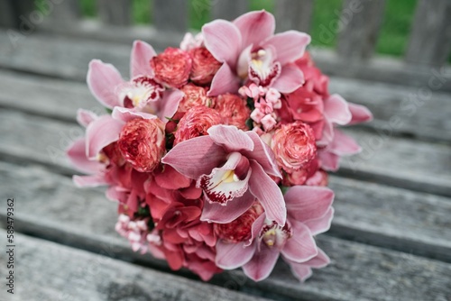 Closeup of a beautiful pink flowers' bouquet on a wooden bench