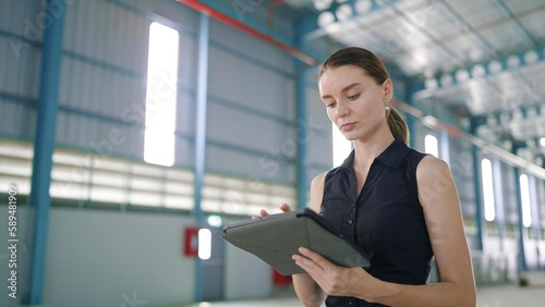 Free Download Caucasian woman manager using tablet for work and recheck the orderliness or stock of product in the factory or warehouse - GFXLoad