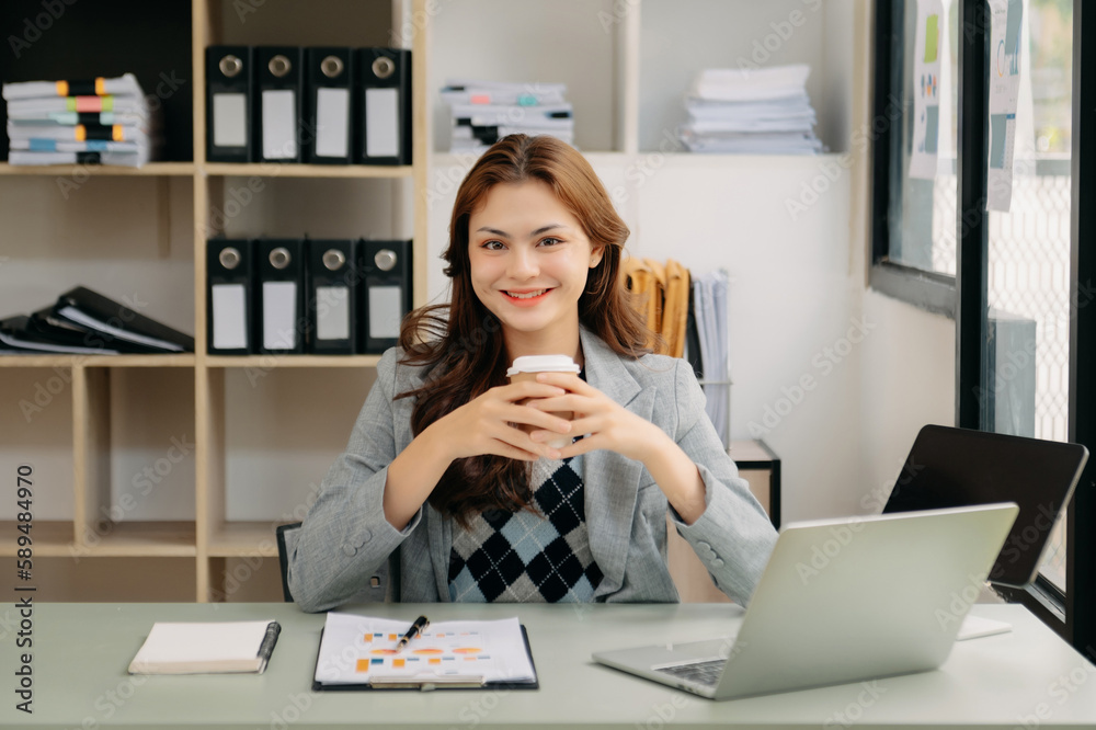 Asian businesswoman working in the office with working notepad, tablet and laptop documents . Asian businesswoman working in the office with working notepad, tablet and laptop documents .