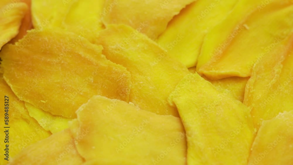 Mango Slices, Fresh Dried Mango Pieces, Fruit, Macro, Rotate. Yellow Abstract Isolated Background of Mango Slices. Healthy Vitamin Food and Diet. Mango Slices, Fresh Dried Mango Pieces, Fruit, Macro, Rotate. Yellow Abstract Isolated Background of Mango Slices. Healthy Vitamin Food and Diet.