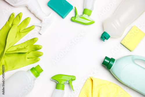 Bottles with Ecological Cleaning Agent, Green cleaning Sponges and Gloves on White Background