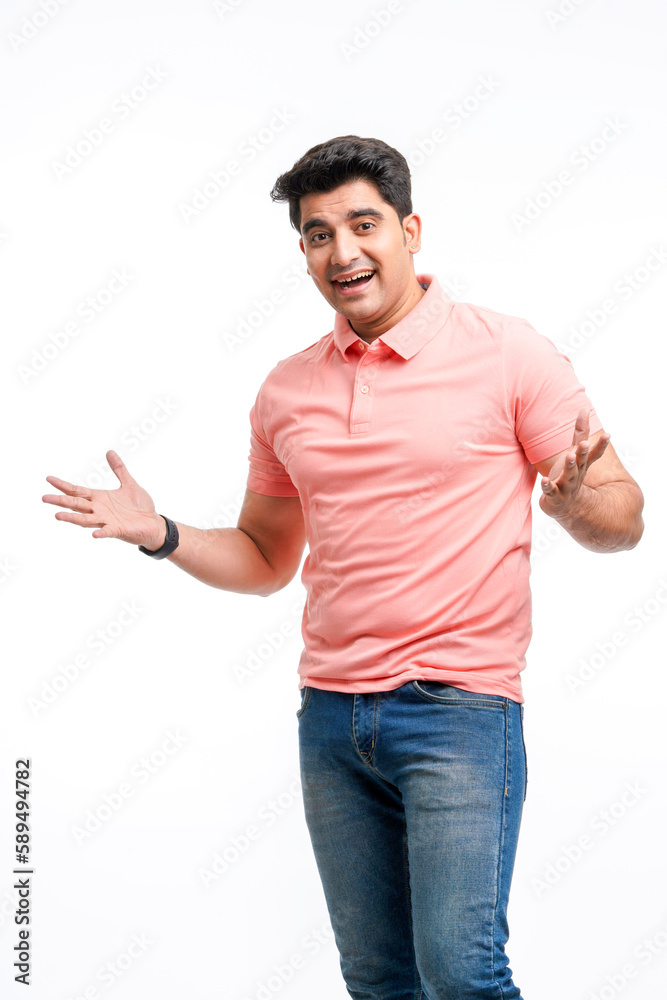 Young indian man spreading hand and giving expression.