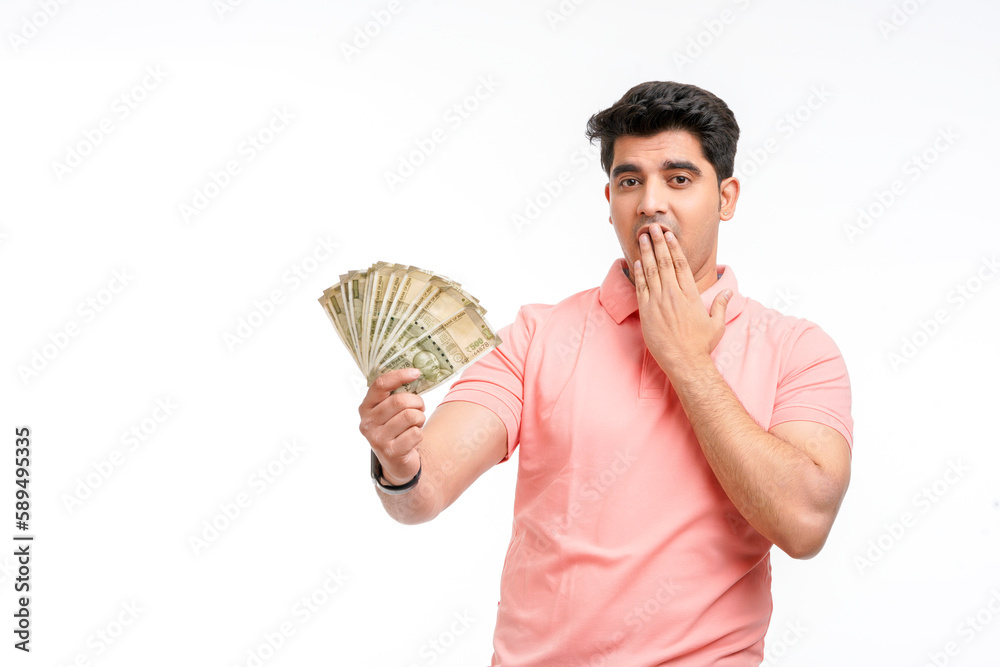 Indian man holding five hundred bank note in hand and giving unbelievable expression. Indian man holding five hundred bank note in hand and giving unbelievable expression.