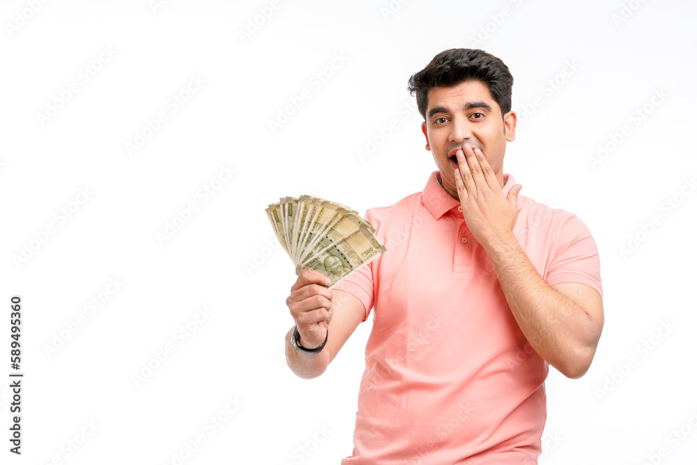 Indian man holding five hundred bank note in hand and giving unbelievable expression. Indian man holding five hundred bank note in hand and giving unbelievable expression.