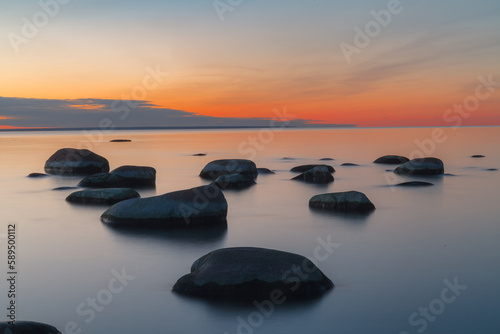 Sunset long exposure on the Baltic sea coast with boulders