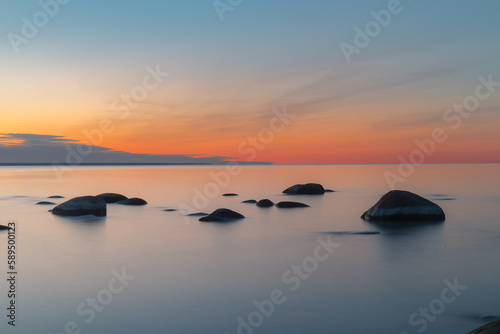 Fototapeta Naklejka Na Ścianę i Meble -  Sunset long exposure on the Baltic sea coast with boulders