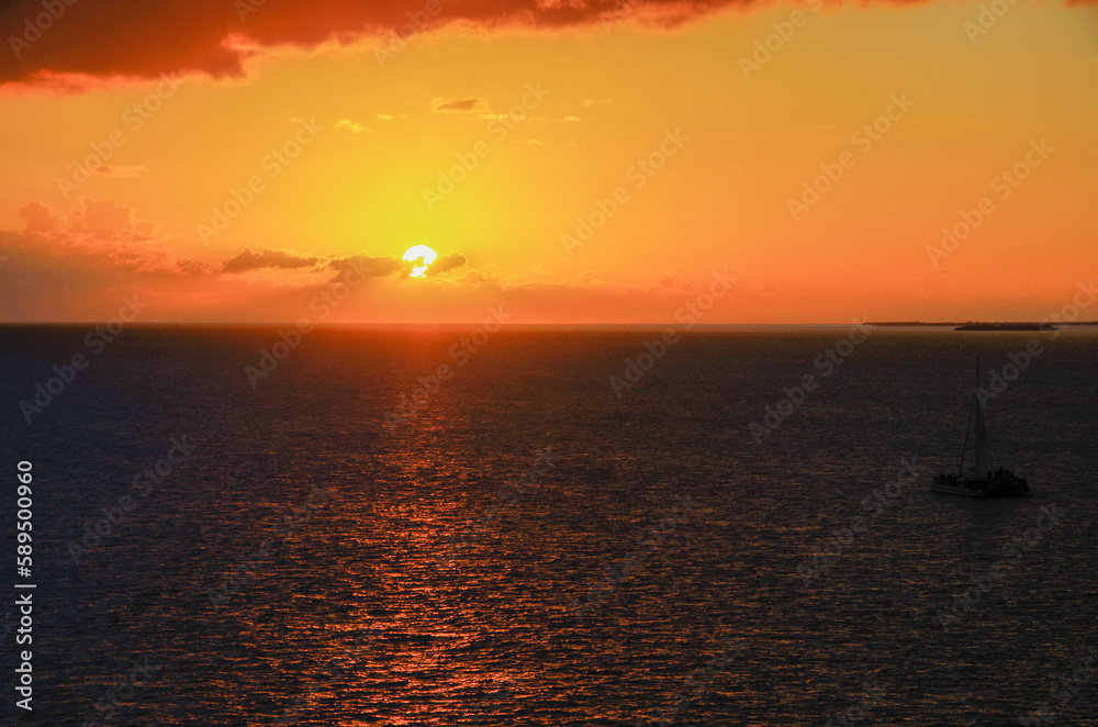 Beautiful dramatic sunset sunrise twilight blue hour seascape scenery over ocean with horizon and clouds cloudscape from cruiseship cruise ship liner sail away from Nassau, Bahamas