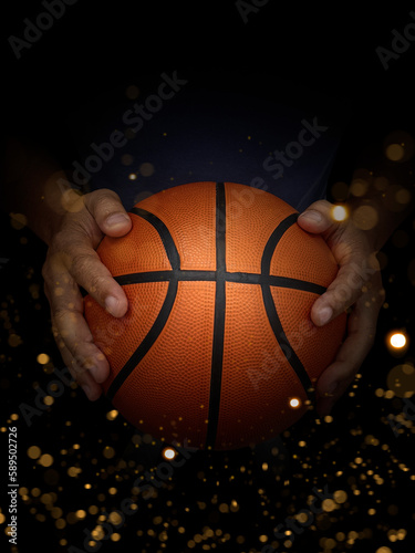 Basketball ball in male hands on black background with abstract lights
