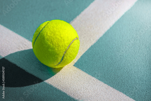close-up of a tennis ball balancing on the edge of a tennis net © Павел Мещеряков