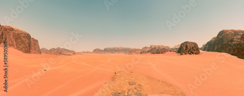 Impresionante paisaje del desierto de Wadi Rum, en Jordania, con altas montañas rocosas y caminos desérticos que guían a los turistas. photo
