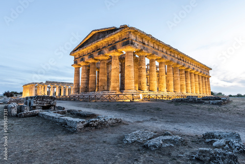 View of Second Temple of Hera and Poseidon temple in Paestum archeological site at sunset, Paestum, Salerno, Campania, Italy. photo