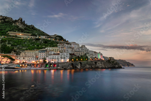 View of Amalfi town along the Amalfi coast facing the Mediterranean Sea at sunset, Salerno, Campania, Italy.