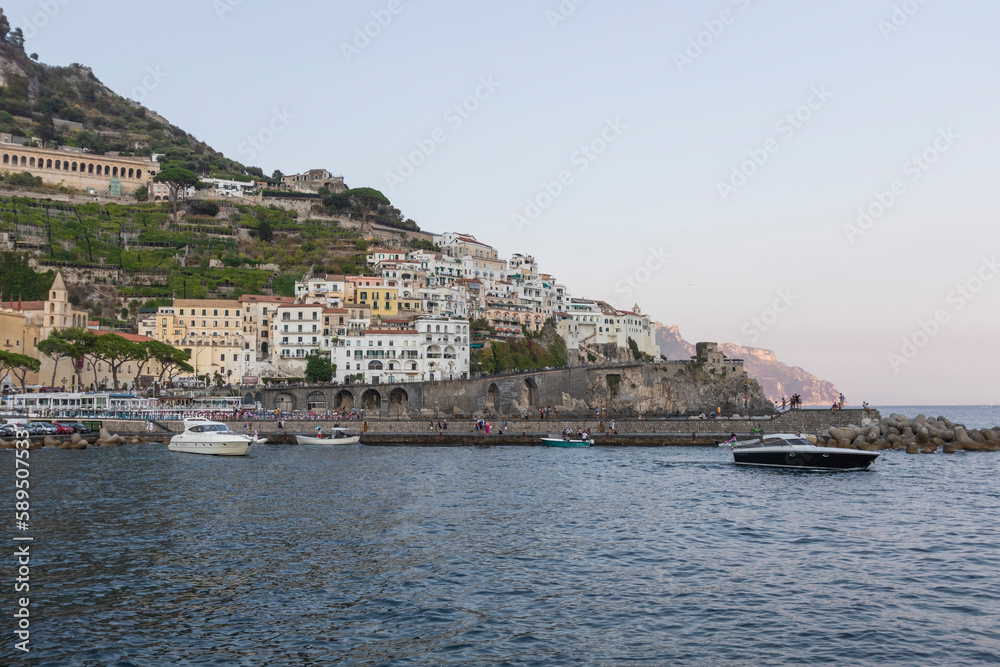 View of Amalfi town along the Amalfi coast facing the Mediterranean Sea at sunset, Salerno, Campania, Italy. View of Amalfi town along the Amalfi coast facing the Mediterranean Sea at sunset, Salerno, Campania, Italy.