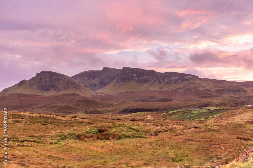 View of mountain landscape at sunset on Scottish Highlands region, Isle of Skye, Scotland, United Kingdom. View of mountain landscape at sunset on Scottish Highlands region, Isle of Skye, Scotland, United Kingdom.