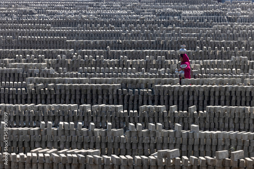 Keraniganj, Dhaka, Bangladesh - 7 November 2022: view of a woman working in the brick field. photo