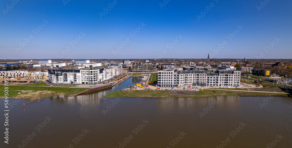 Aerial wide panoramic view on recreational port and Kade Zuid construction site of the new Noorderhaven neighbourhood along the river IJssel in Zutphen, The Netherlands