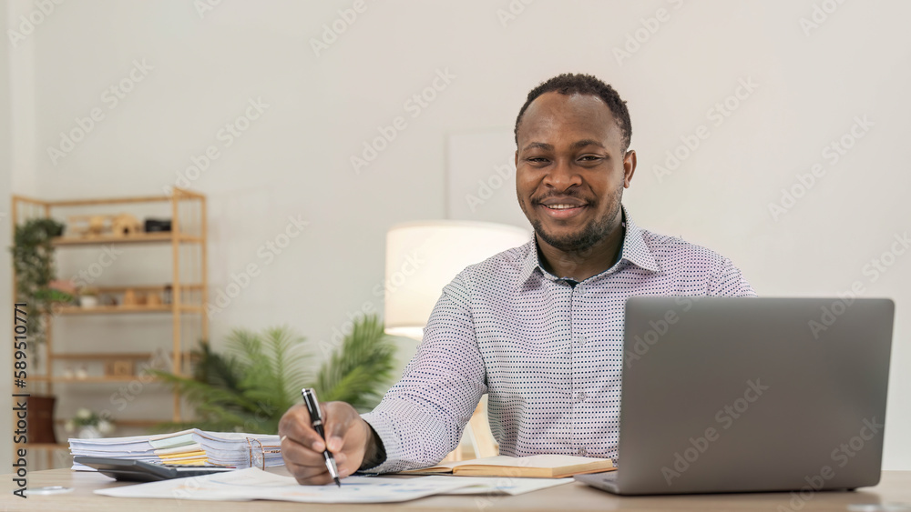 custom made wallpaper toronto digitalPortrait of handsome African black young business man working on laptop at office desk.