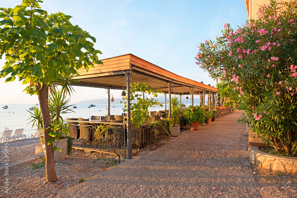 seaside promenade Moscenicka Draga, with oleander bush and restaurant beside