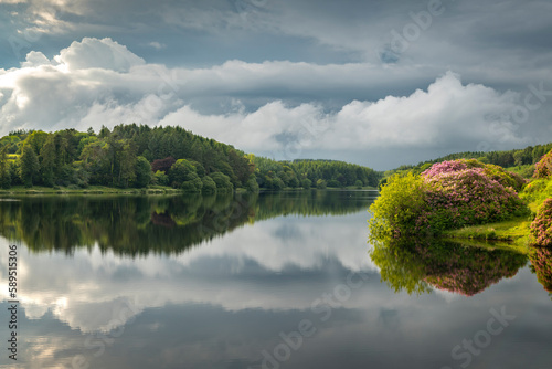 Reflections on a calm summer evening at Kennick Reservoir, Dartmoor National Park, Devon