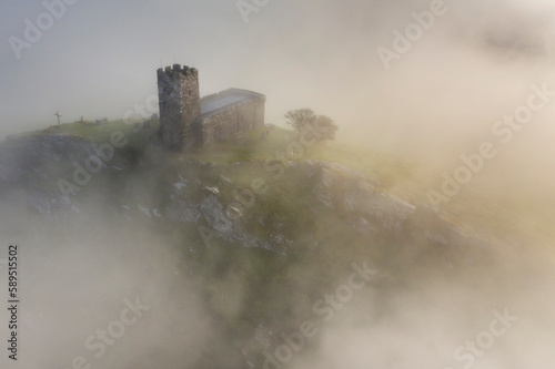 St. Michael de Rupe Church on the summit of Brentor on a misty September morning, Dartmoor, Devon photo