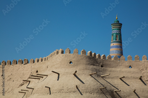 Fortress Wall, Islam Khoja Minaret in the background, Ichon Qala (Itchan Kala), UNESCO World Heritage Site, Khiva, Uzbekistan photo