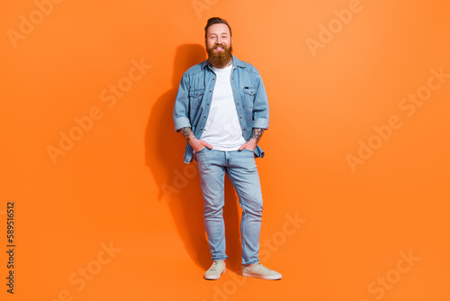 Full length photo of good mood youth guy standing with hands in pockets advertise boutique ads isolated vivid color background