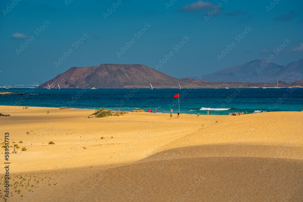 View of beach, Lobos Island and the Atlantic Ocean on a sunny day, Corralejo Natural Park, Fuerteventura View of beach, Lobos Island and the Atlantic Ocean on a sunny day, Corralejo Natural Park, Fuerteventura